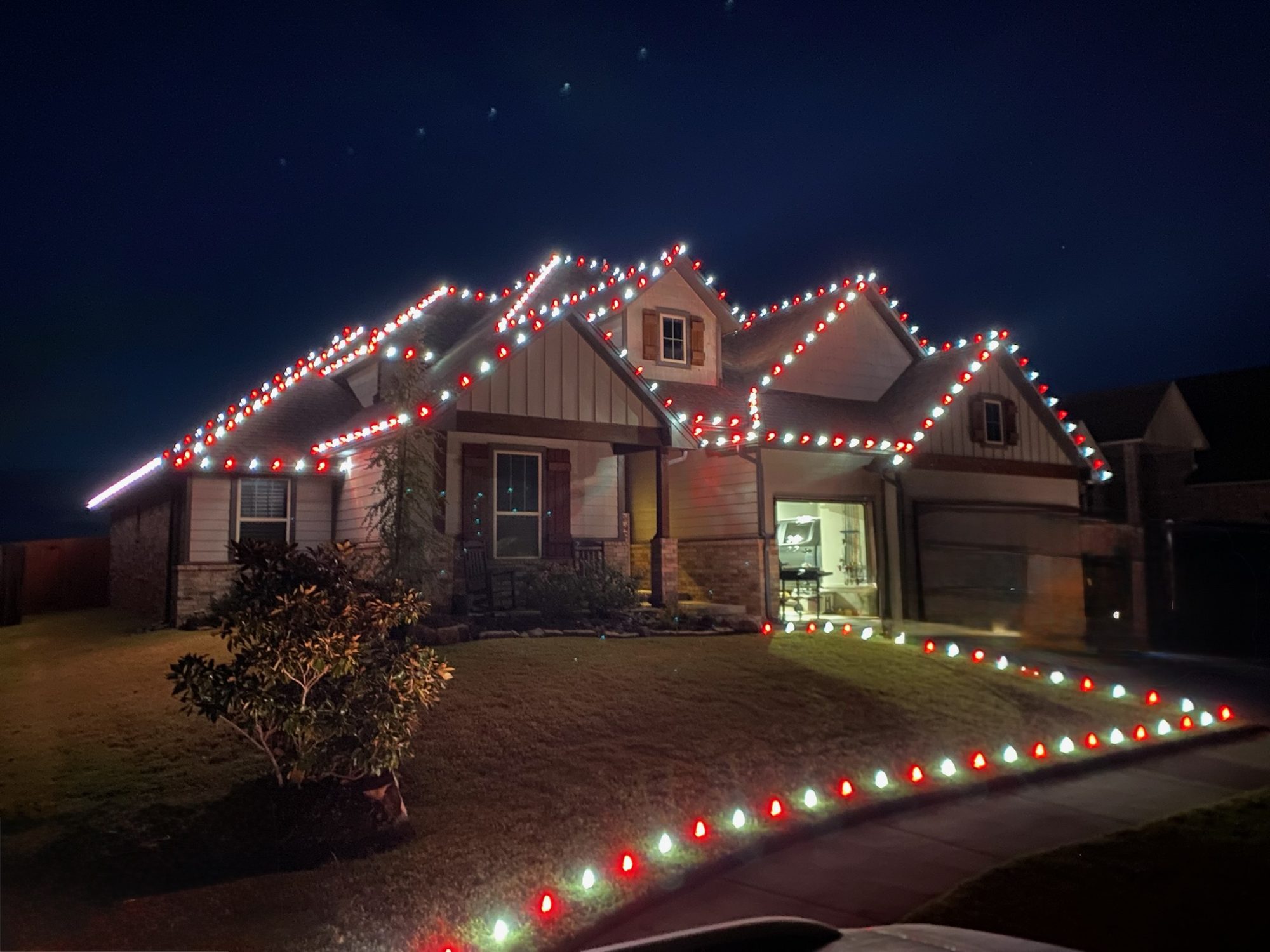 Edmond home outlined in warm white Christmas lights along every roofline and gable, installed by Brandon Seasonal Solutions