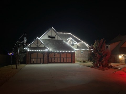 Garage and roofline outlined in crisp white lights at night